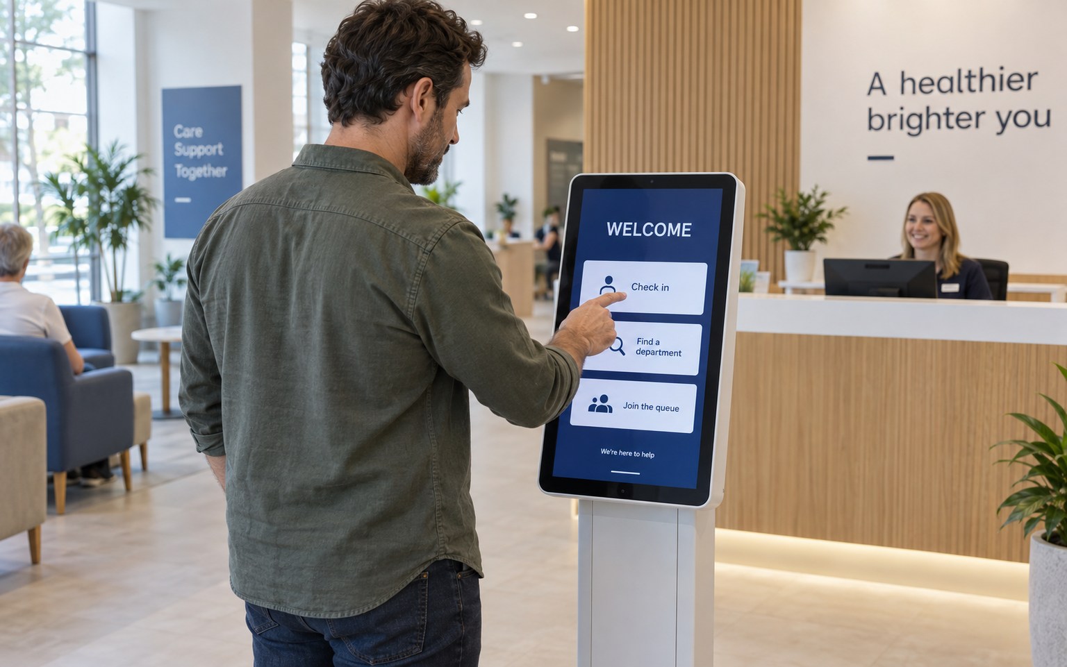 Visitor checking in at a clinic touchscreen kiosk